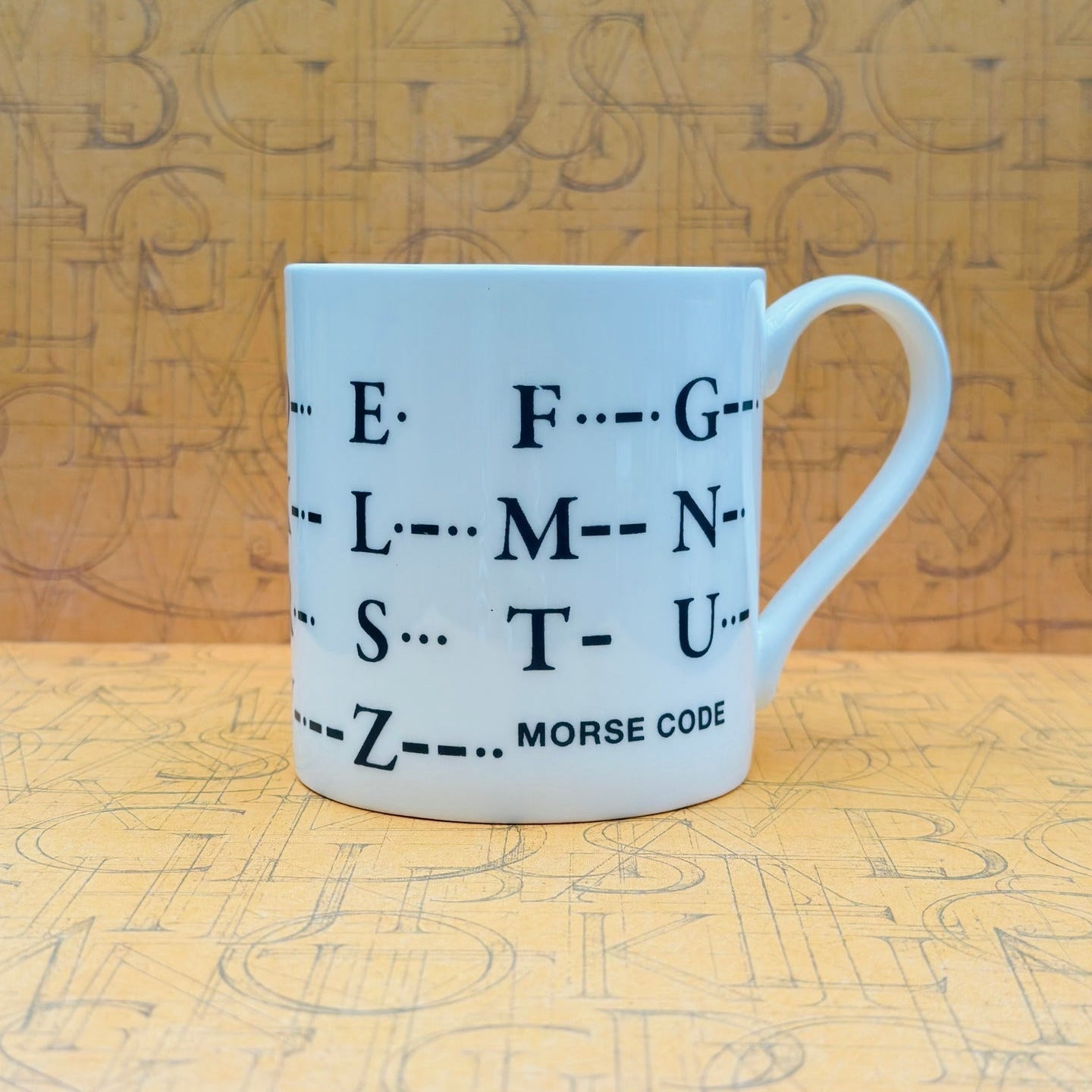Mug with Morse code design on a wooden background